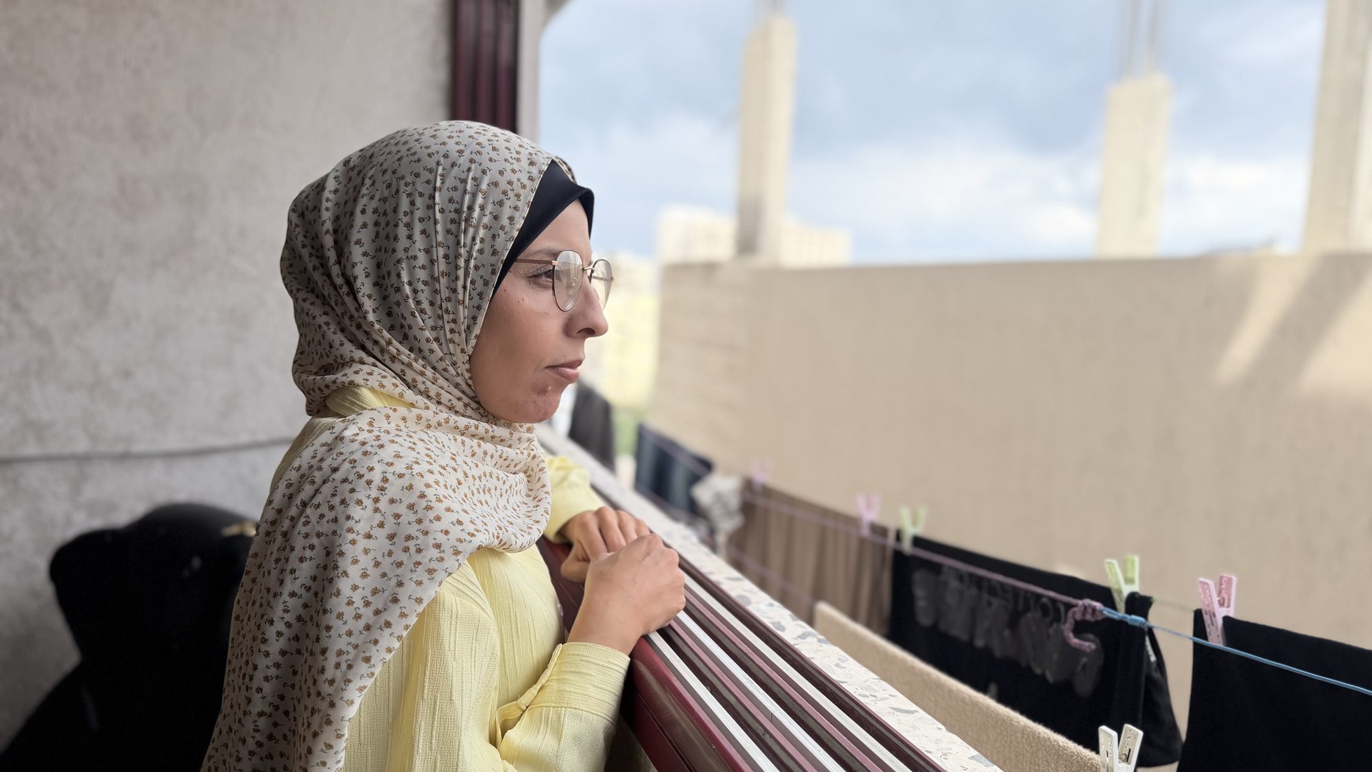 Samah Asfour looks out from a balcony